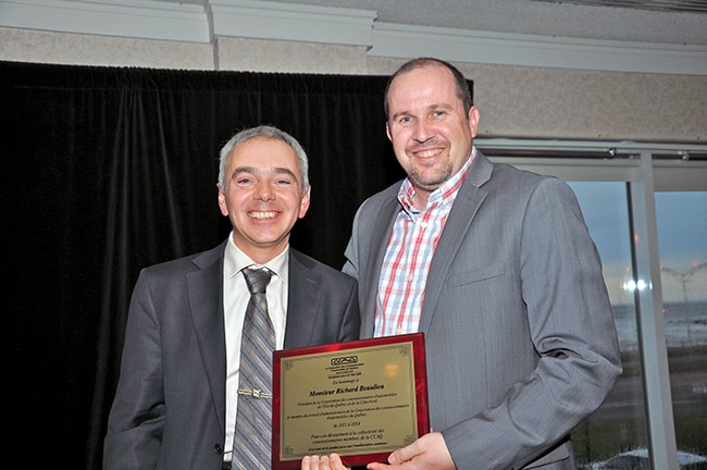M. Francis Lamontagne remet une plaque-souvenir en guise de reconnaissance de son dévouement à M. Richard Beaulieu de la Corporation des concessionnaires d’automobiles de l’Est-du-Québec et de la Côte-nord.